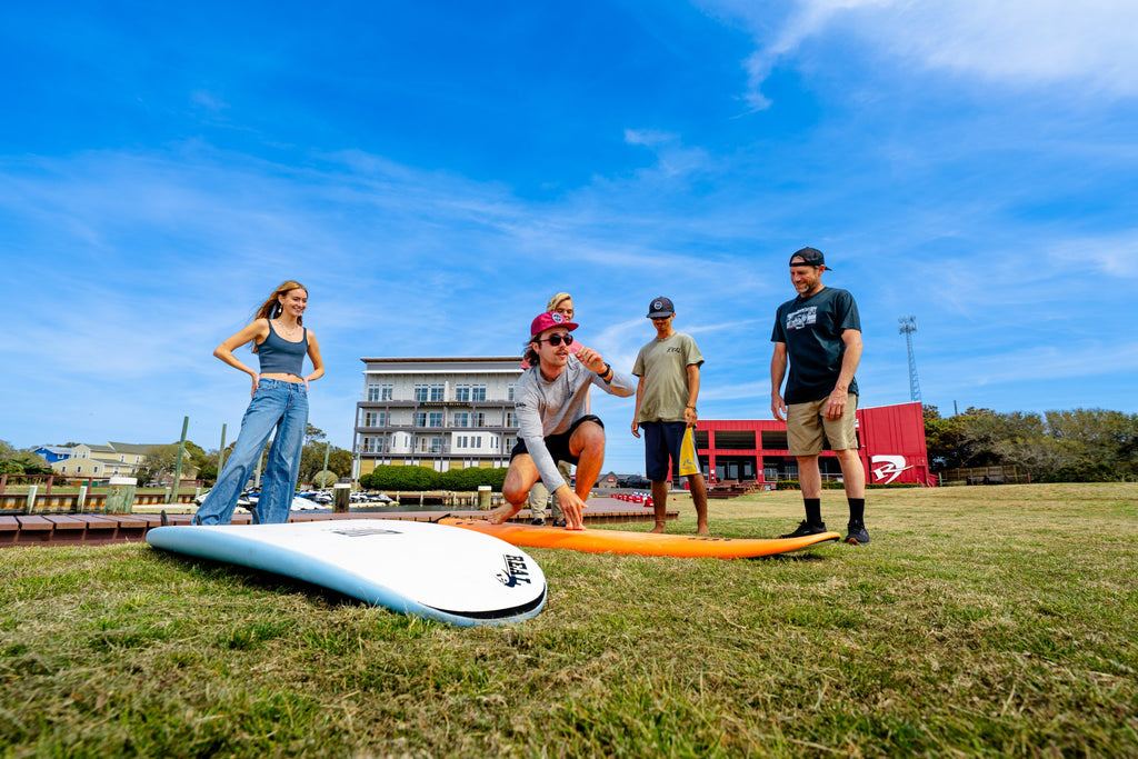 Beginner learning surf fundamentals during Surfing 101