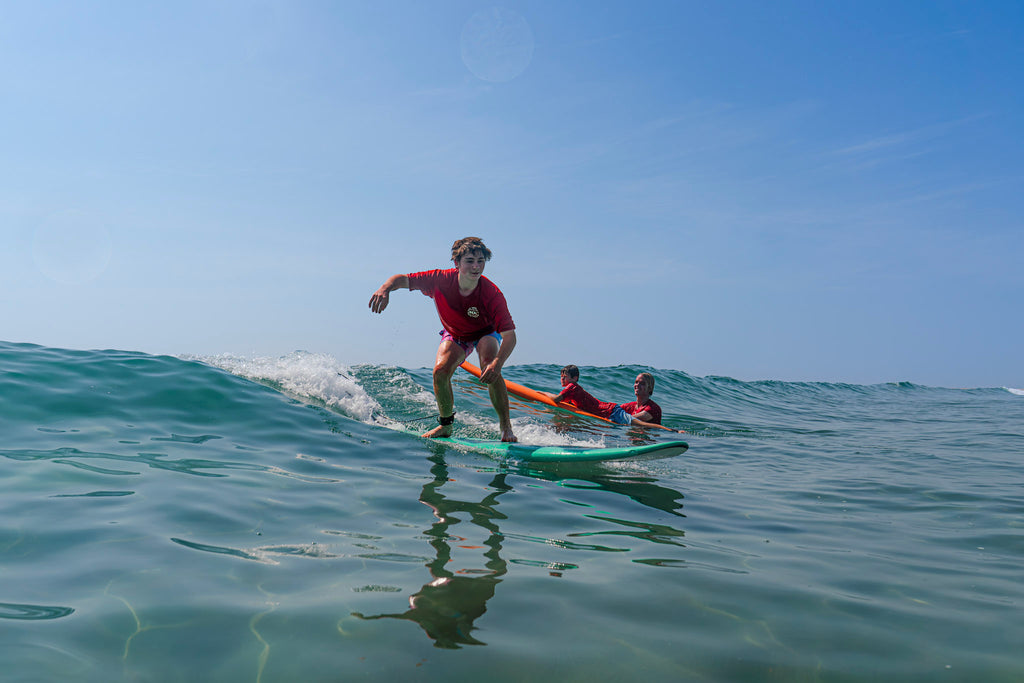 Surfers sharing a customized lesson with a REAL coach