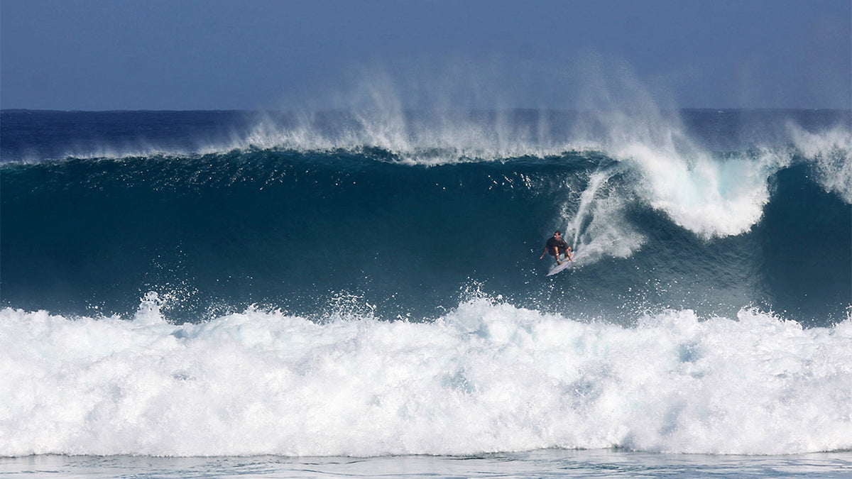 A surfer riding a powerful hurricane swell