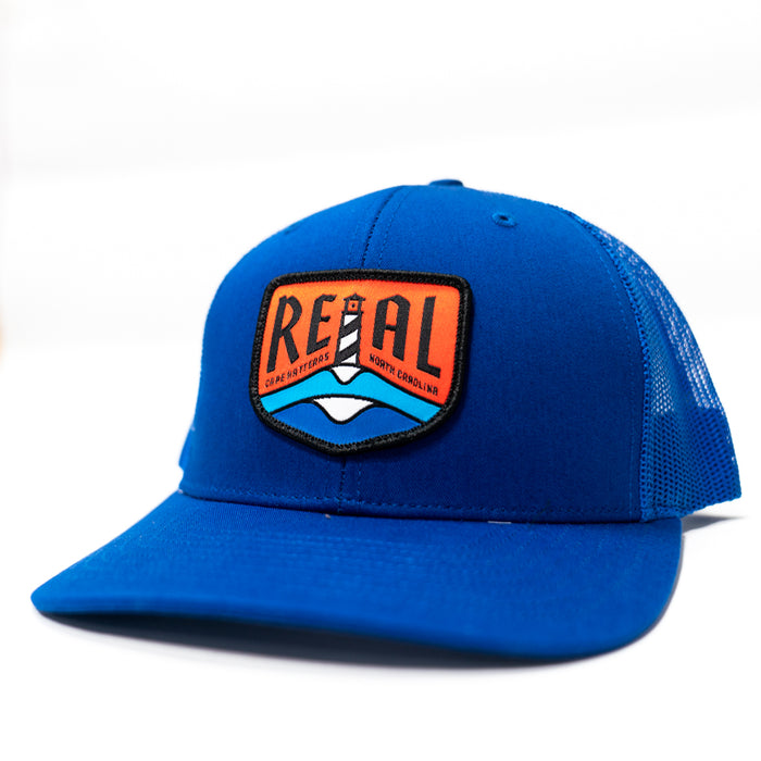 REAL Lighthouse Badge Trucker Hat-Royal