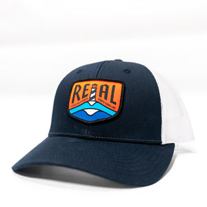 REAL Lighthouse Badge Trucker Hat-Navy/White